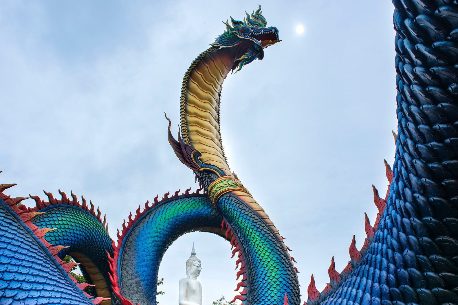 Blue-green Naga sculpture at Wat Roi Phra Phutthabat Phu Manorom in Mukdahan