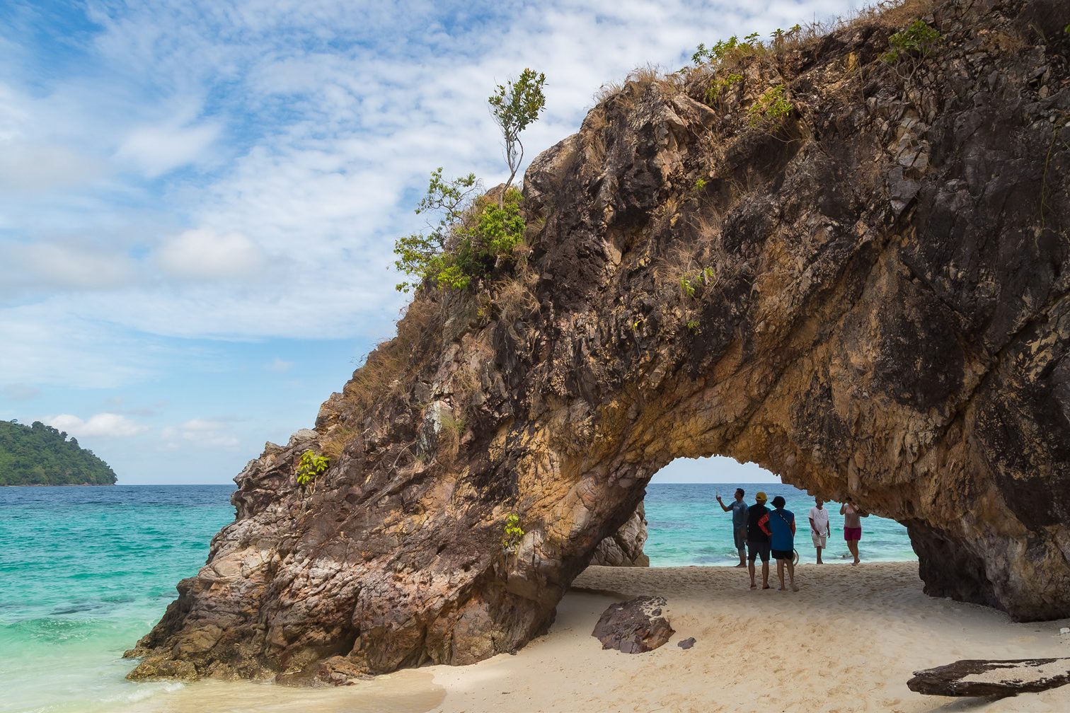 Natural stone arch on the beach at Ko Khai in Tarutao National Park, Satun