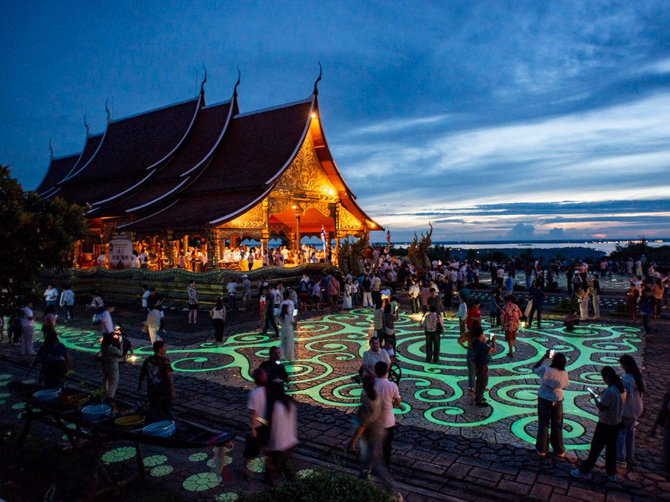 Wat Sirindhorn Wararam Phu Phrao, the Glowing Temple, lit up at dusk in Ubon Ratchathani